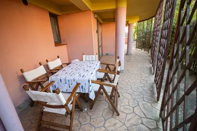 a white table and chairs on a patio at The Family Courtyard - Very LARGE 2BD Apartment by Flat Manаger in Ravda