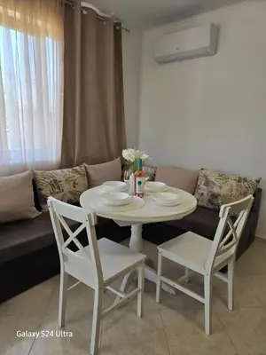 a white table and chairs in a living room with a couch at Elia Relax & Lux in Aheloy