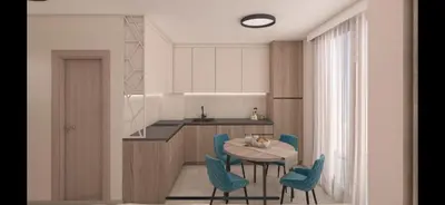 a kitchen with a table and blue chairs at Sorento Sole Mare in Sveti Vlas