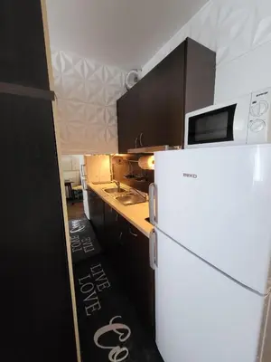 a kitchen with a white refrigerator and a microwave at Sunny View SP apartments in Bŭnzareto