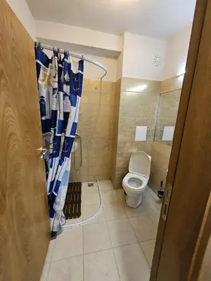 a bathroom with a toilet and a shower curtain at Sunny View SP apartments in Bŭnzareto