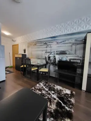 a living room with a table and a car mural at Sunny View SP apartments in Bŭnzareto