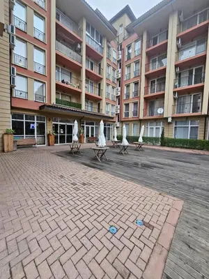 two benches with umbrellas in front of a building at Sunny View SP apartments in Bŭnzareto
