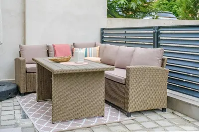 a wicker couch and chairs on a patio at BellaViaStay, Flat Apolonia 1BD in Burgas City