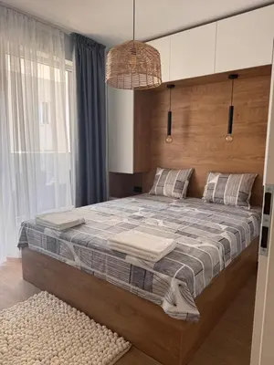 a bedroom with a large bed with a large window at South Beach Apartment Primorsko 2 in Primorsko