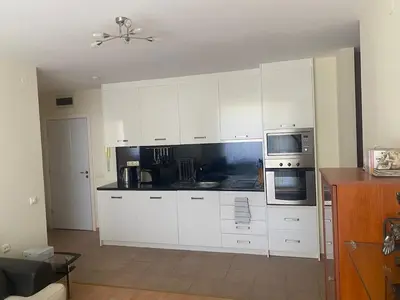 a white kitchen with white cabinets and appliances at Pool View, 2 Bedroom Apartment in Sunny Beach