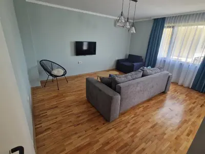a living room with a couch and a television at Flowers Apartments in Nesebar