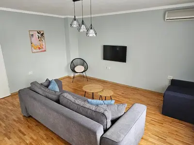a living room with a couch and a table at Flowers Apartments in Nesebar