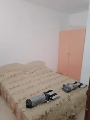 a bed with two pairs of slippers on it at 3 room apartment Sanny Day 2 in Sunny Beach