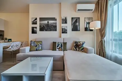 a living room with a couch and a table at Varna South Bay - Monk Apartment in Varna City