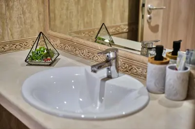 a sink in a bathroom with a mirror at Varna South Bay - Monk Apartment in Varna City