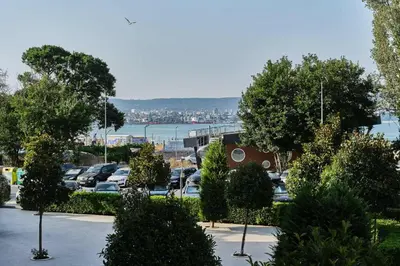 a parking lot with cars parked in a parking lot at Varna South Bay - Monk Apartment in Varna City