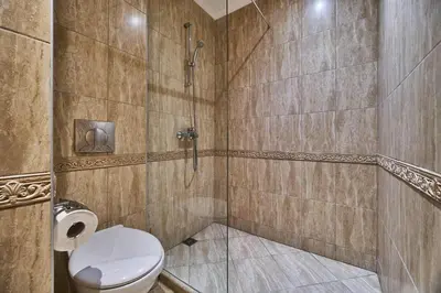 a bathroom with a toilet and a shower at Varna South Bay - Monk Apartment in Varna City
