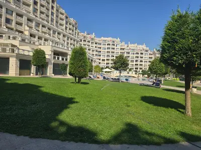 a park in front of a large apartment building at Varna South Bay - Monk Apartment in Varna City