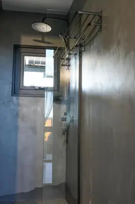 a glass shower in a bathroom with a window at Elysium Lozenets in Lozenets