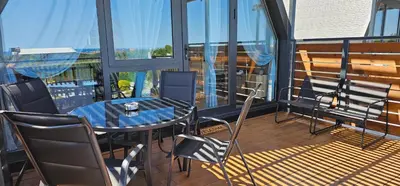 a balcony with a table and chairs on a balcony at Elysium Lozenets in Lozenets