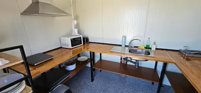 a kitchen with a sink and a microwave on a wooden table at Elysium Lozenets in Lozenets