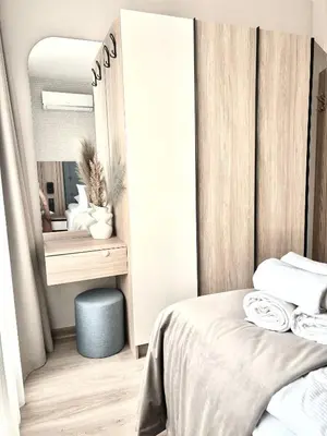a bedroom with a large mirror and a bed at Sorrento E 4 4 Sveti Vlas in Sveti Vlas