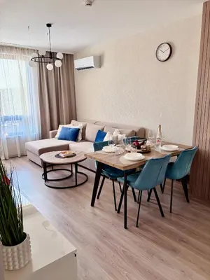 a living room with a couch and a table and chairs at Sorrento E 4 4 Sveti Vlas in Sveti Vlas