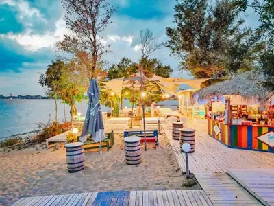 a beach with chairs and umbrellas on the beach at Sorrento E 4 4 Sveti Vlas in Sveti Vlas