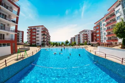 a large swimming pool with people in the water at Grand rezort Marína Beach in Sveti Vlas
