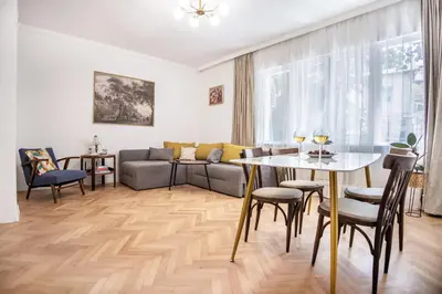 a living room with a table and a couch at Downtown Central point Varna Apartment in Varna City