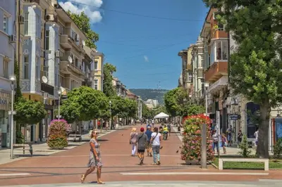 a group of people walking down a city street at Downtown Central point Varna Apartment in Varna City