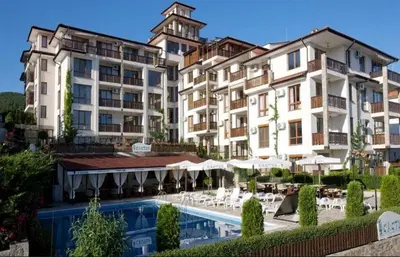 a group of buildings with a pool and tables and umbrellas at Tryavna Beach Violet 42 in Sveti Vlas