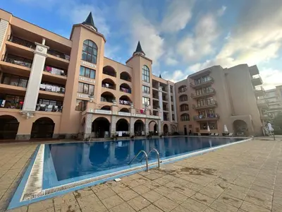 a large building with a swimming pool in front of it at Palazzo Sunny beach in Sunny Beach