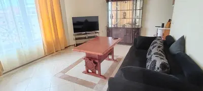a living room with a couch and a wooden table at Palazzo Sunny beach in Sunny Beach