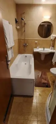 a bathroom with a large tub and a sink at Palazzo Sunny beach in Sunny Beach