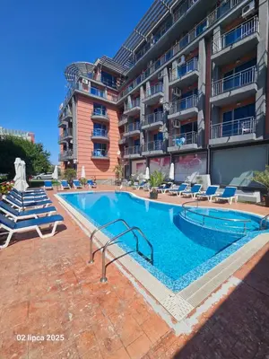 a swimming pool in front of a building at Cacao Residence in Sunny Beach