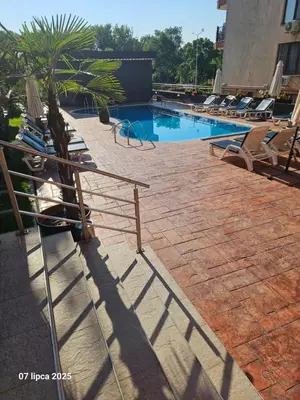 a swimming pool with chaise lounges and a swimming pool at Cacao Residence in Sunny Beach
