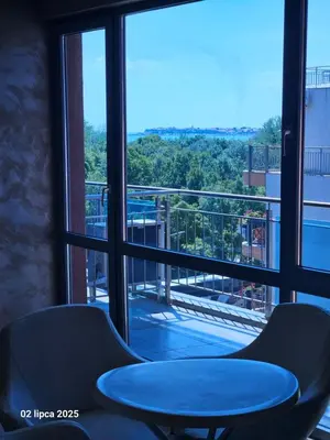 a table and two chairs in front of a window at Cacao Residence in Sunny Beach