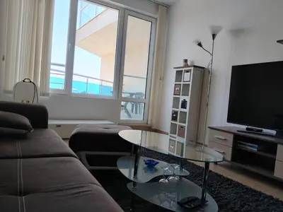 a living room with a couch and a table and a television at 2 Room Apartment Costa Calma Aheloy Bulgarien in Aheloy