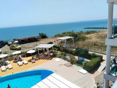 a view of a swimming pool and the ocean at 2 Room Apartment Costa Calma Aheloy Bulgarien in Aheloy