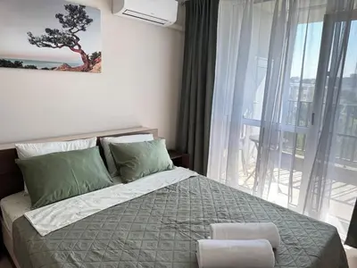 a bedroom with a bed and a large window at Valentina Apartment in Burgas City