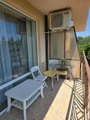 a patio with a table and chairs on a balcony at Orchid Fort Garden in Sunny Beach