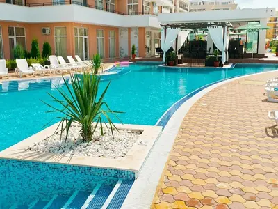 a large swimming pool in a building with a resort at Grand Кameliq - MORSKI BRIZ apartment in Sunny Beach