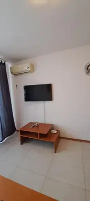 a living room with a flat screen tv on a wall at Grand Кameliq - MORSKI BRIZ apartment in Sunny Beach