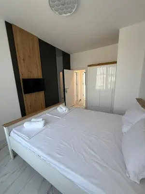 a large white bed with two white towels on it at Aurum Villas Smokinya Beach 2 in Sozopol