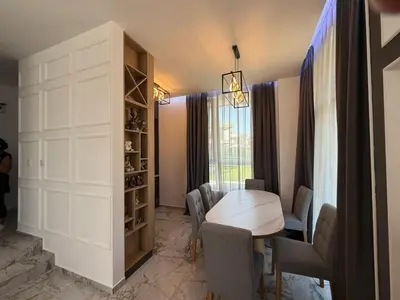 a dining room with a table and chairs at Aurum Villas Smokinya Beach 2 in Sozopol