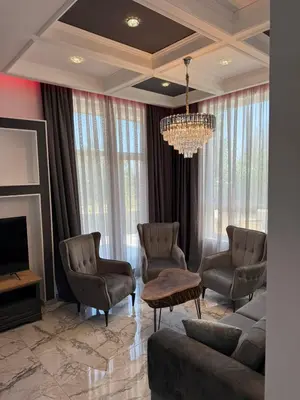 a living room with a couch and chairs and a chandelier at Aurum Villas Smokinya Beach 2 in Sozopol