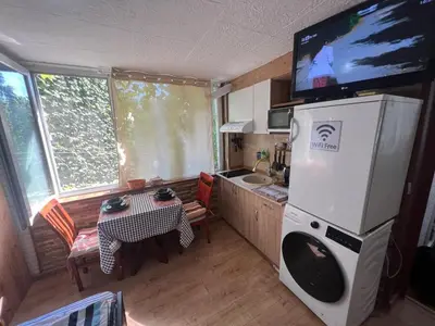 a kitchen with a tv on top of a refrigerator at Studio Vili 2 in Varna City