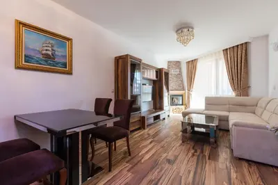 a living room with a couch and a table at Boutique Apart Hotel Versis in Sunny Beach