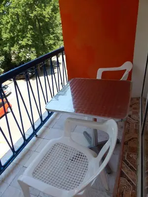 a table and a chair on a balcony at Hotel Maria in Kiten