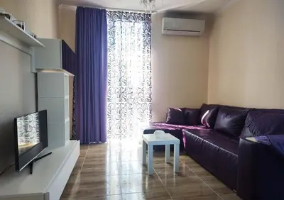 a living room with a purple couch and a table at Blue Beach Apartments - Amara in Ravda