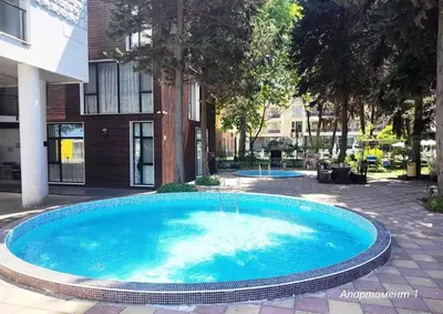 a large blue swimming pool in front of a building at Blue Beach Apartments - Amara in Ravda