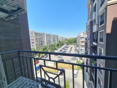 a balcony with a bench and a view of a street at Sunrise Dreams Apartment with free Parking in Burgas City