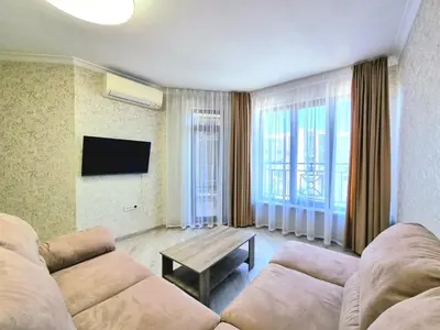 a living room with a couch and a table at Sunrise Dreams Apartment with free Parking in Burgas City
